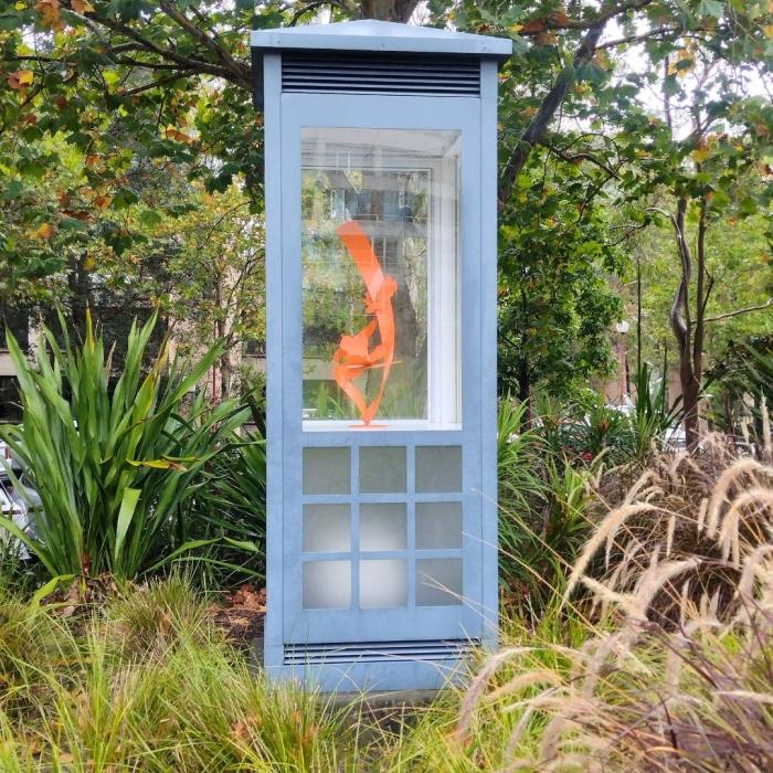 orange sculpture in blue cabinet