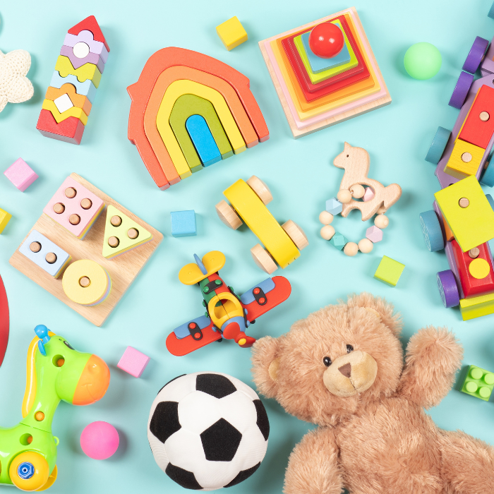 A collection of children's toys including blocks and teddy bear