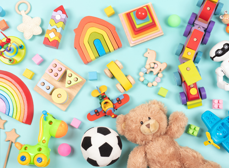 A collection of children's toys including blocks and teddy bear