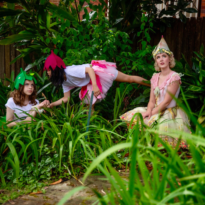 3 girls dressed as fairies in green garden