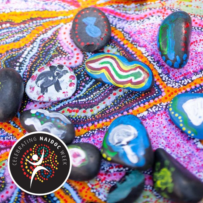 Photo of colourful painted stones in Indigenous Aboriginal art style.