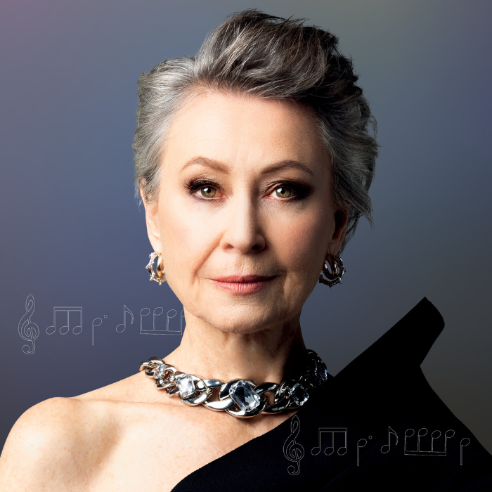 headshot of female opera singer with grey hair and silver necklace