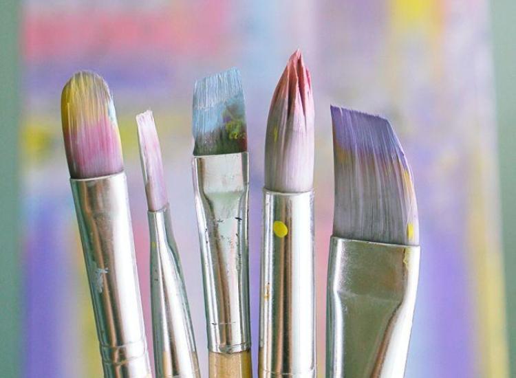 five artists paintprushes on a coloured background