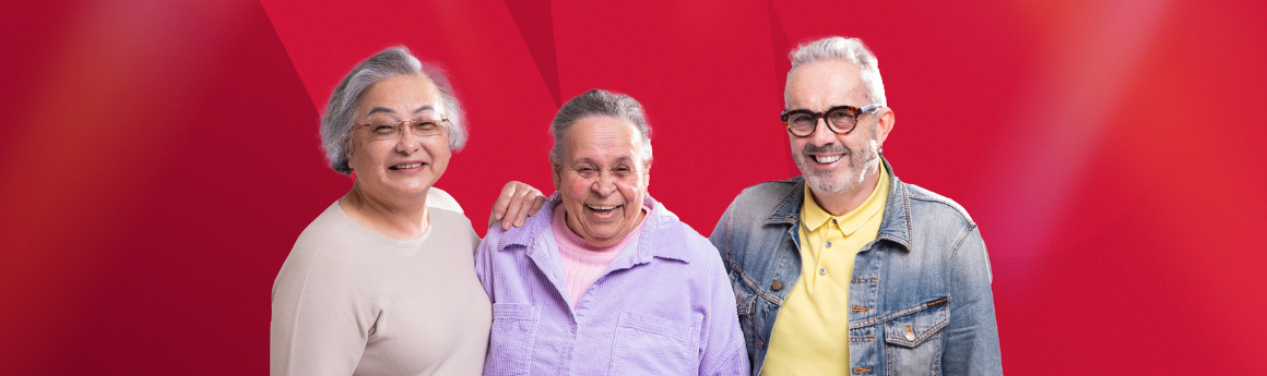 three people standing close to one another smiling with a red background