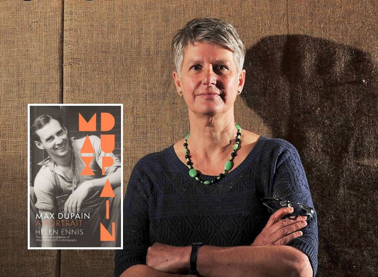 Author photo of Helen Ennis with her book on Max Dupain