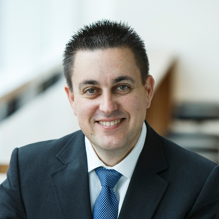 Author photo of Richard Holden in a suit.